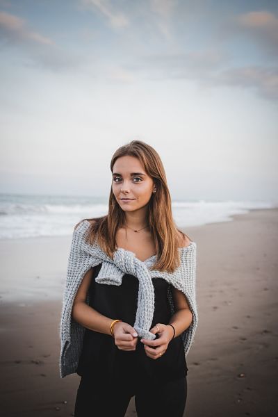 woman-on-beach-with-cardigan