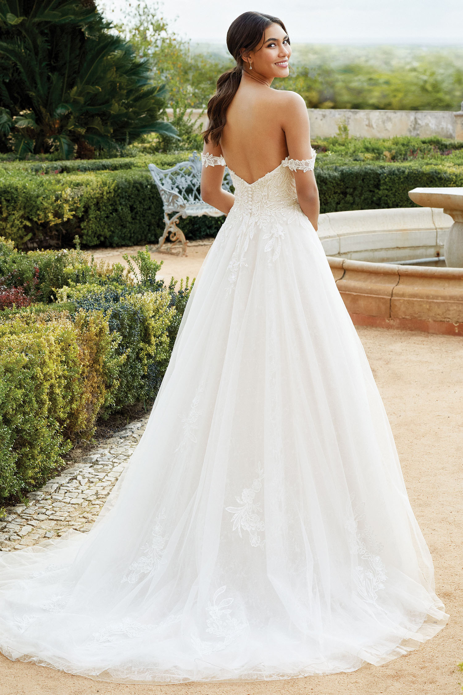 Bride wearing sweetheart necklined princess style gon with arm swags.
