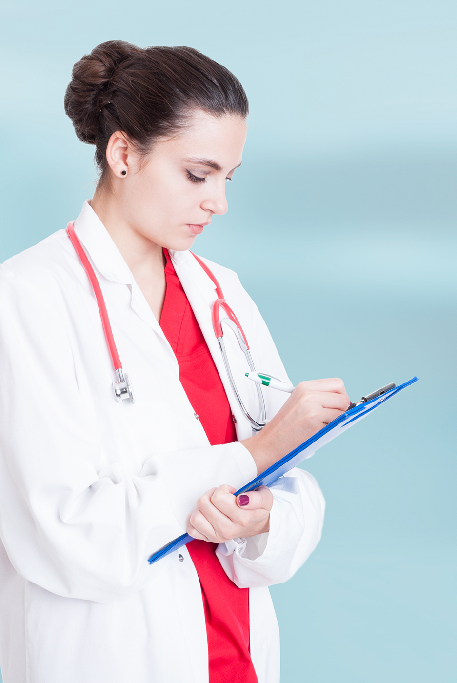 Female medical professional writing on a clipboard