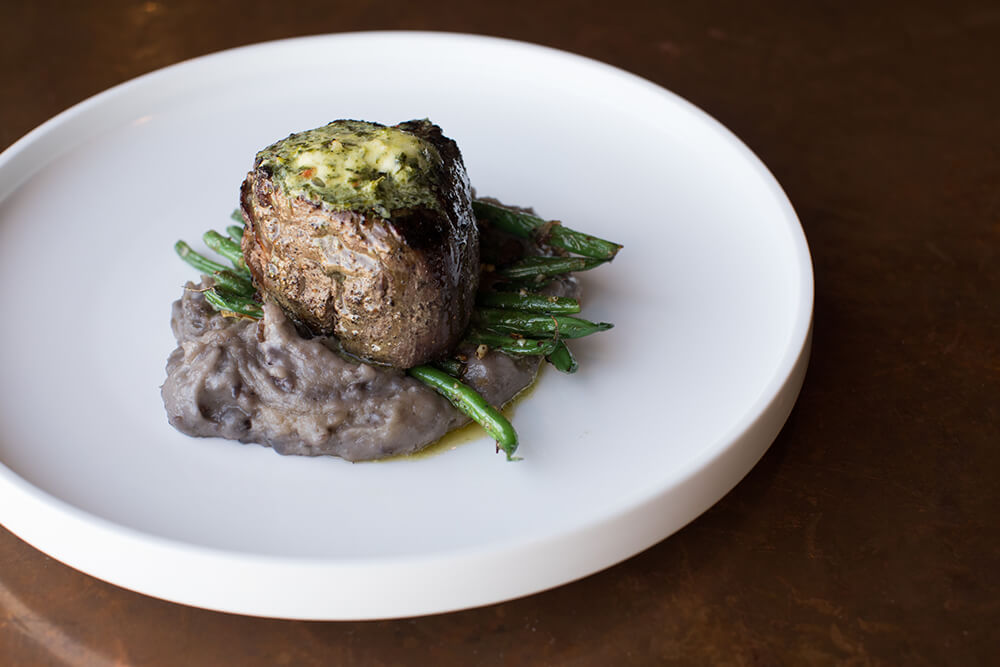 Juniper’s succulent, 10-ounce grilled tenderloin, smothered in chimichurri butter sauce, is one of the best steak experiences you can have in Tulsa. (Photo: Valerie Grant)