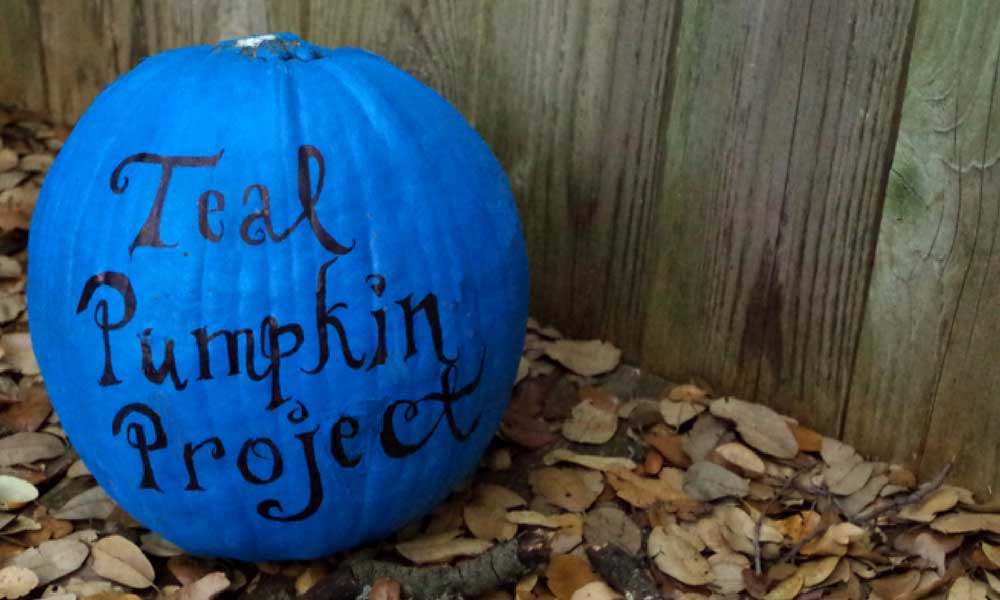 Teal pumpkin in fall texas leaves