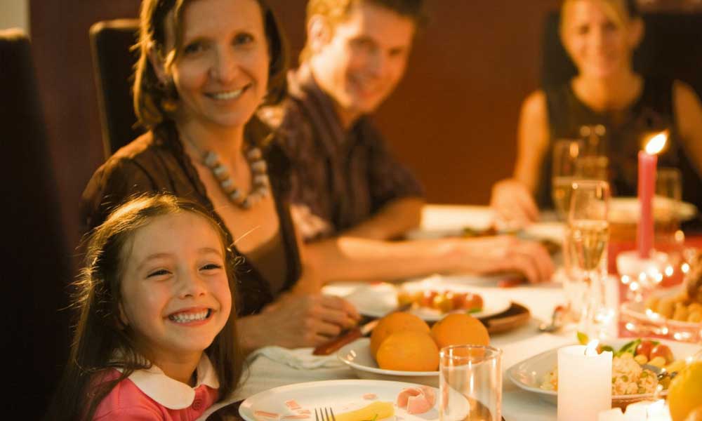Child smiling at family dinner