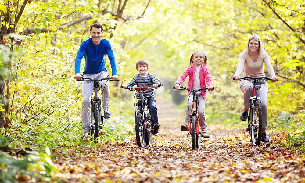 Family riding bicycles in fall
