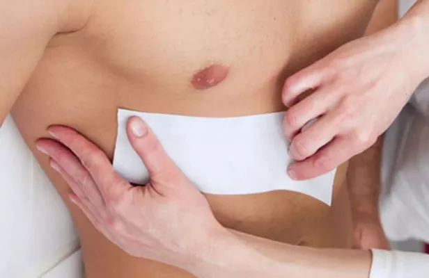 Man with chest being waxed