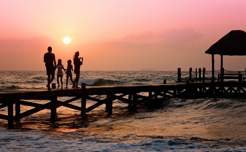 family enjoying the sunset on dock