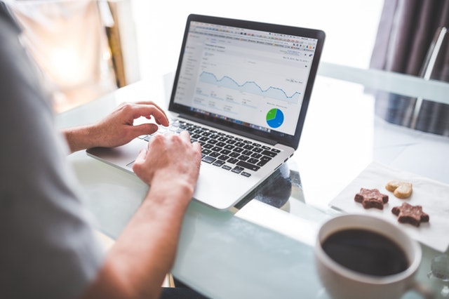 A laptop displaying website analytics charts and graphs.