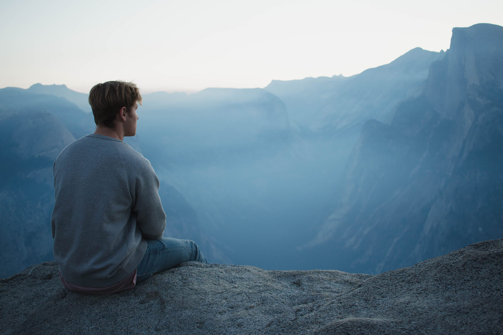 Man meditating on a clifftop