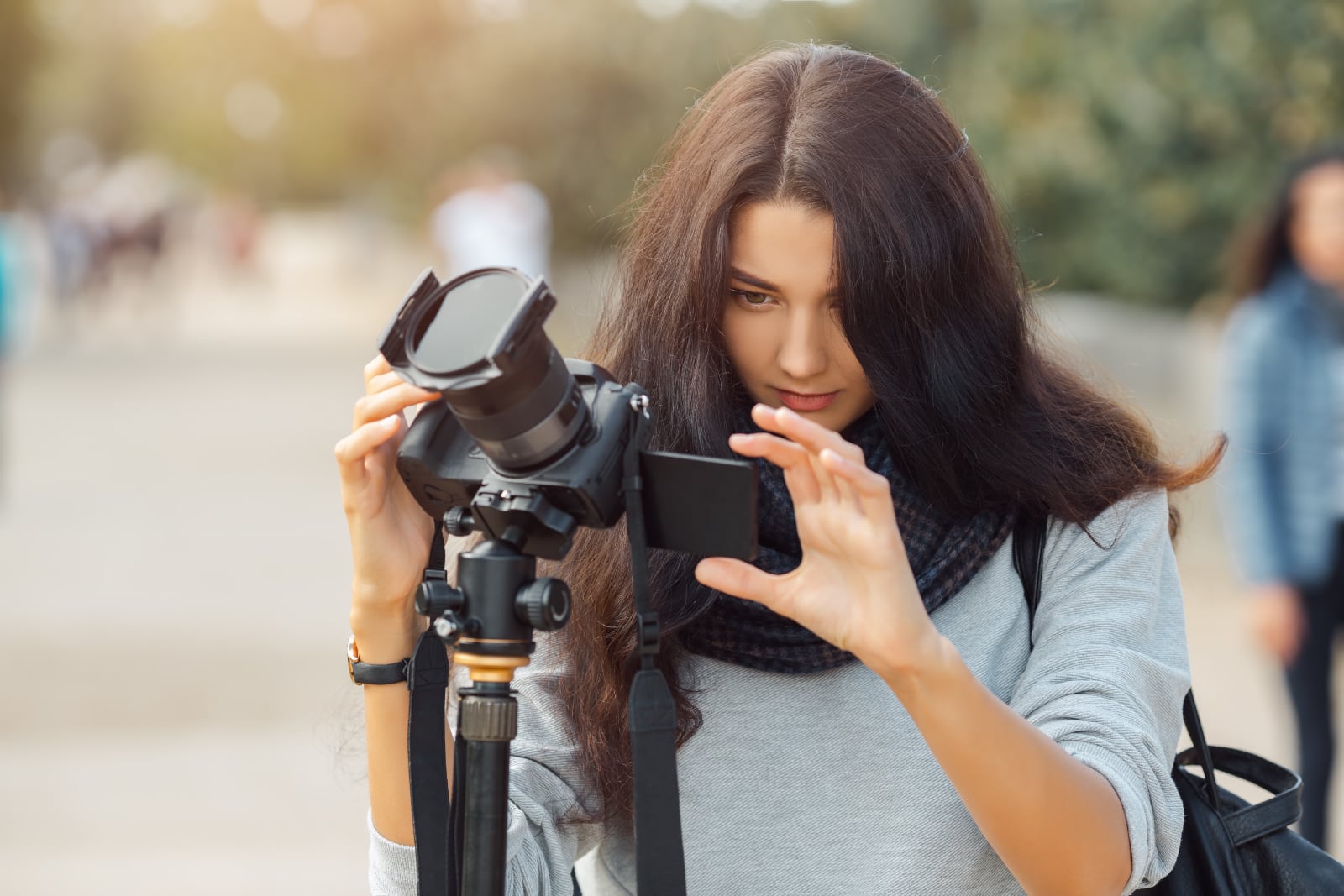 woman-professional-photographer-taking-landscape-images-with-dslr-camera-tripod-outdoors