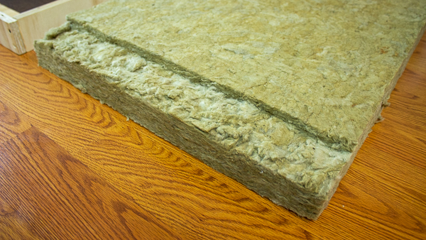 A close up view of insulation that has been cut to accommodate a support strip.