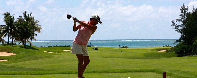 person swinging a golf club