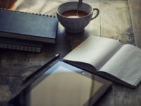 cup of coffee and book of notes