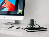 website on computer and a cup of coffee