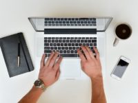 person typing a response on a laptop
