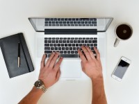 person writing content on laptop
