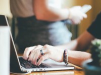 woman writing on laptop