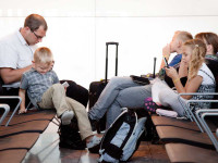 family sitting in an airport