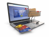 shopping cart on top of a laptop