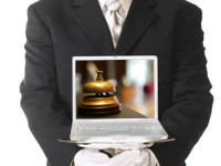 person holding a laptop for guest reviews
