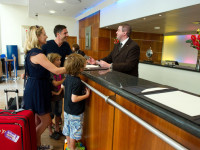 family checking in to a hotel