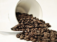 coffee beans spilled from coffee cup