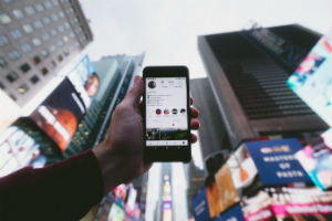 man using phone in city district