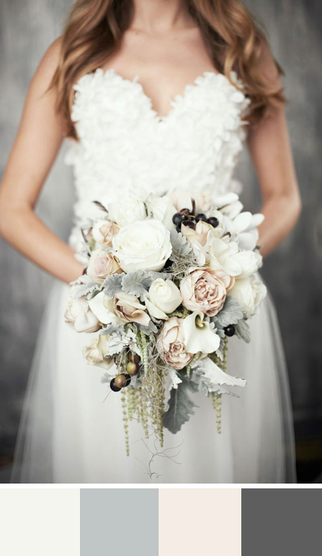 bride holding grey and cream bouquet