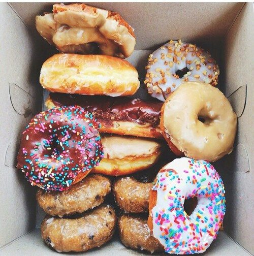 box of a dozen donuts decorated with sprinkles
