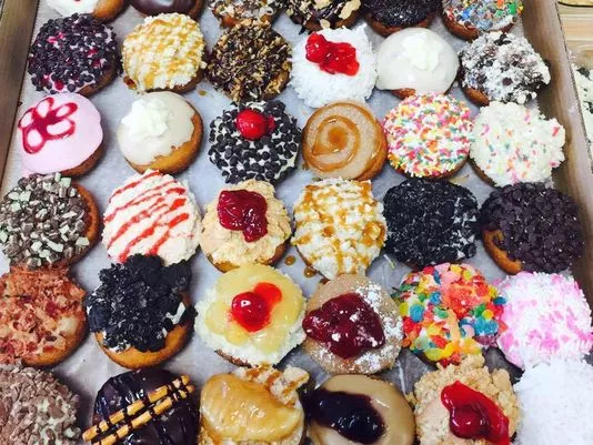three dozen colorfully decorated donuts