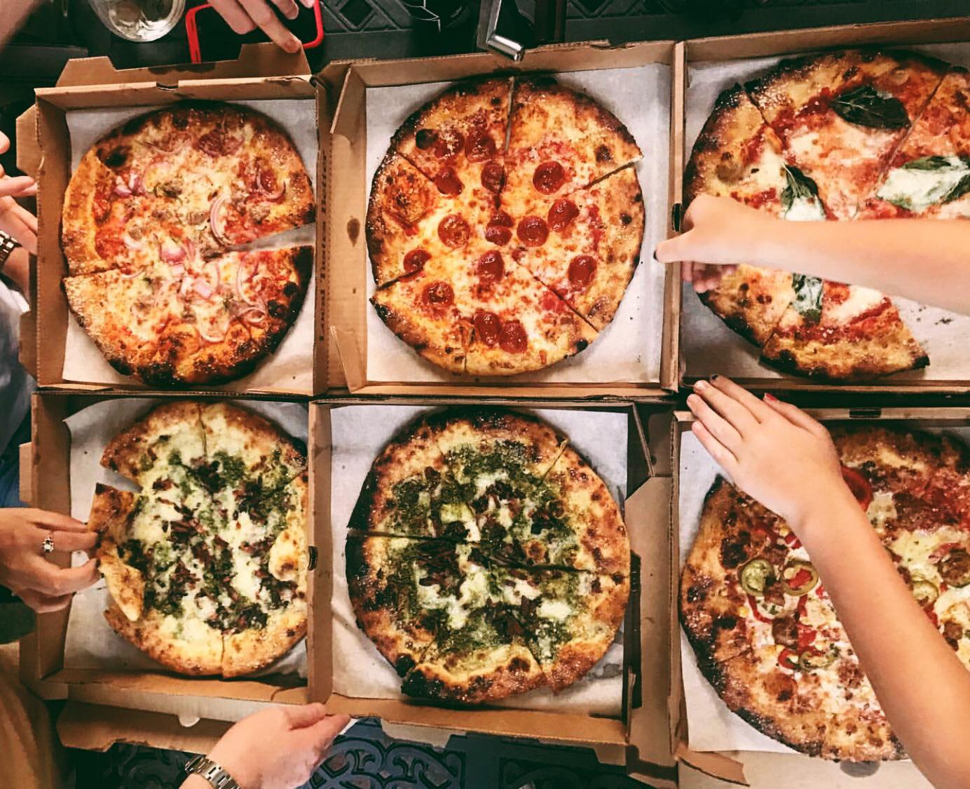 6 pizzas in boxes from Harvest Pizzeria