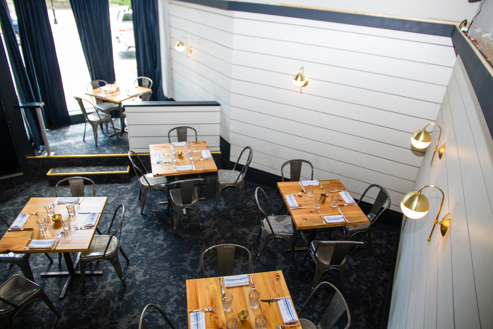 classy interior of Corner Kitchen with nice wooden tables