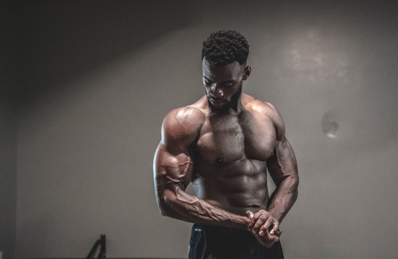 male bodybuilder posing & flexing big muscles