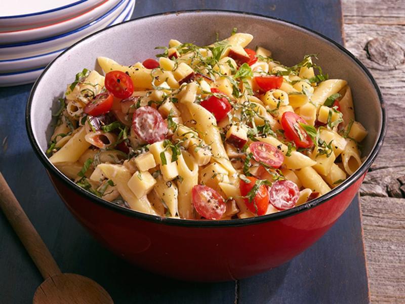 Spicy Pasta Salad with Smoked Gouda, Tomatoes and Basil in a red bowl