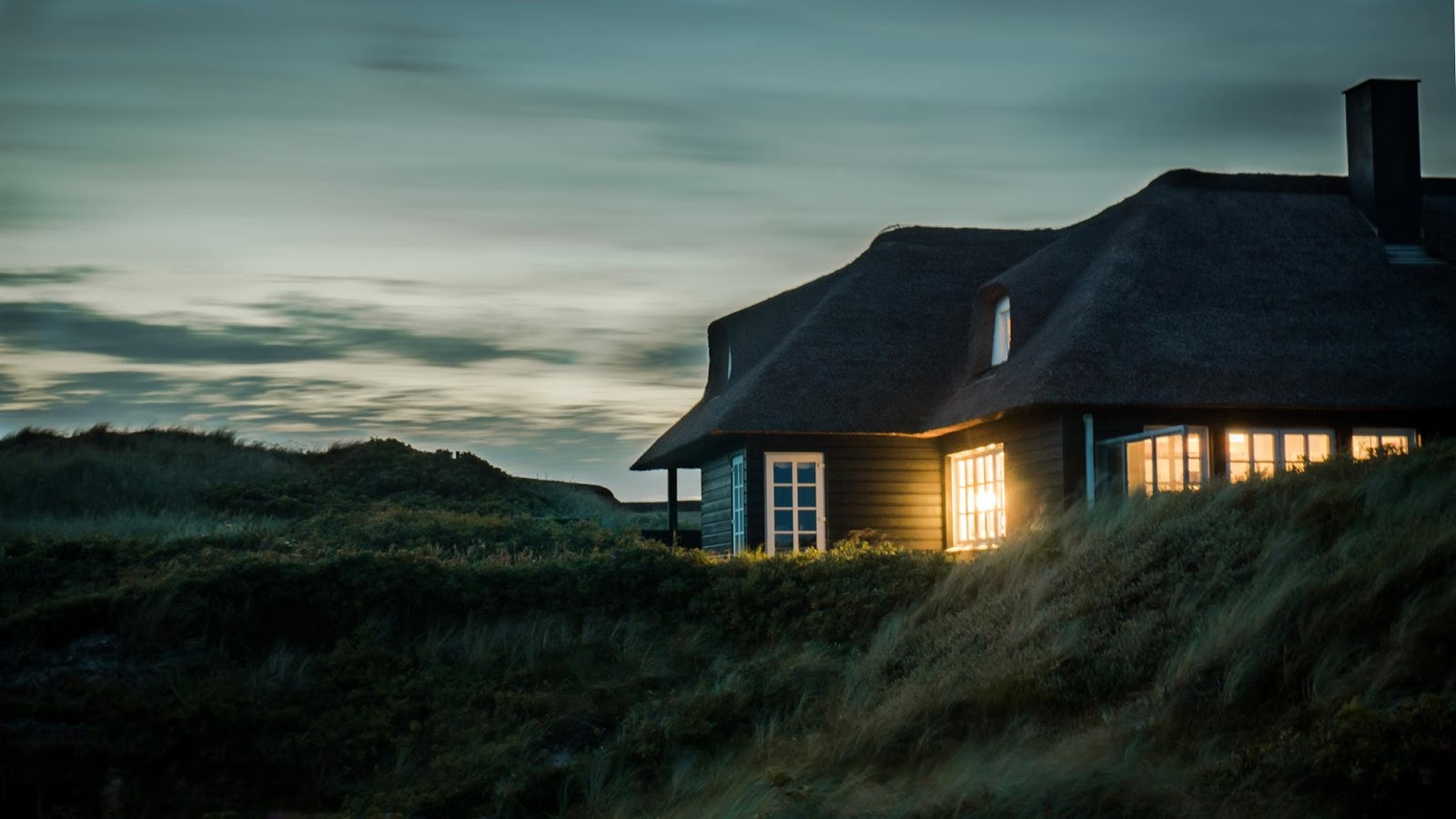 a home sitting on a hilltop at dusk