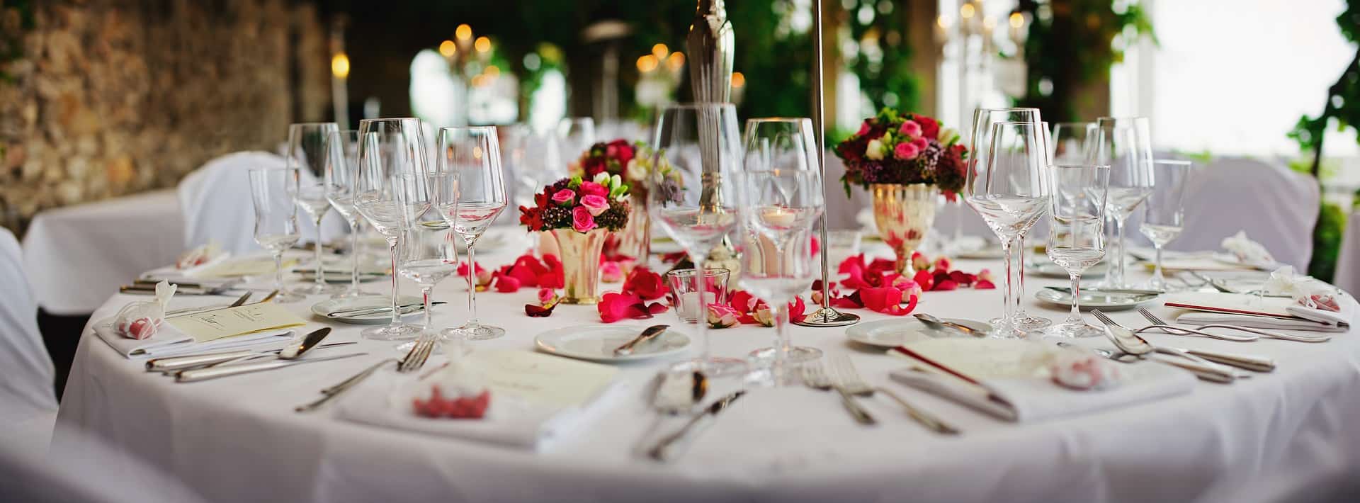 china and rose petals on a white table cloth at a restaurant in london, ohio