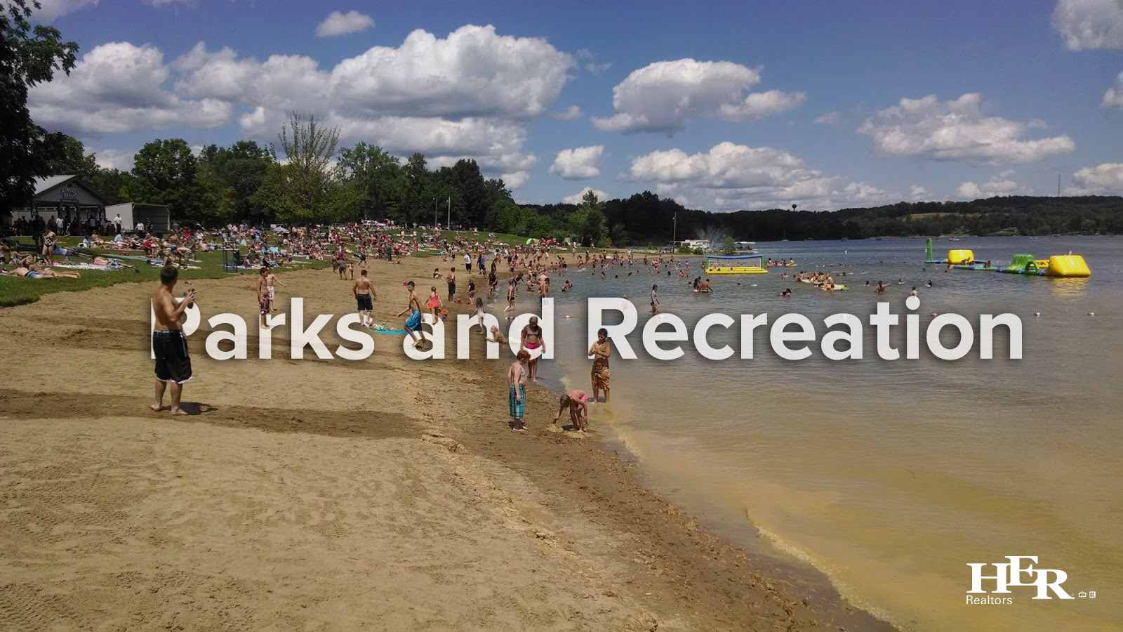 Kids and adults enjoying the sandy beach at Atwood Lake in Ohio.