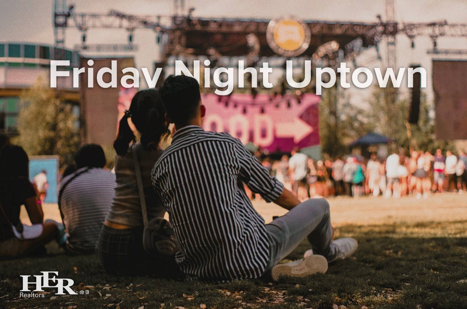 Two people sitting together and looking towards a stage