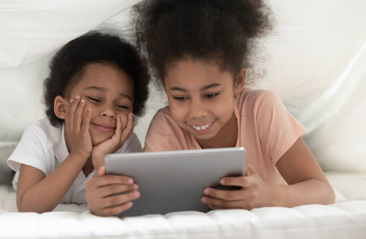 two kids holding an iPad