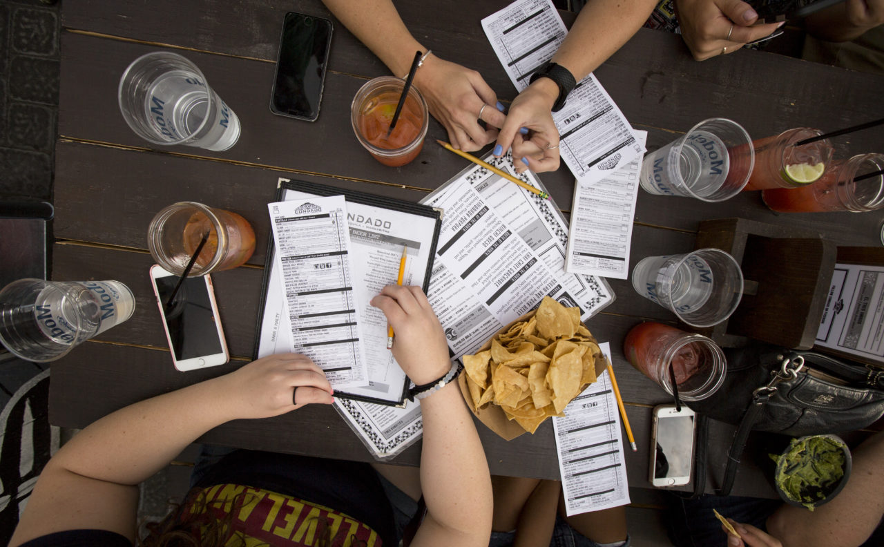 Table at Condado Tacos with chips and menus spread out