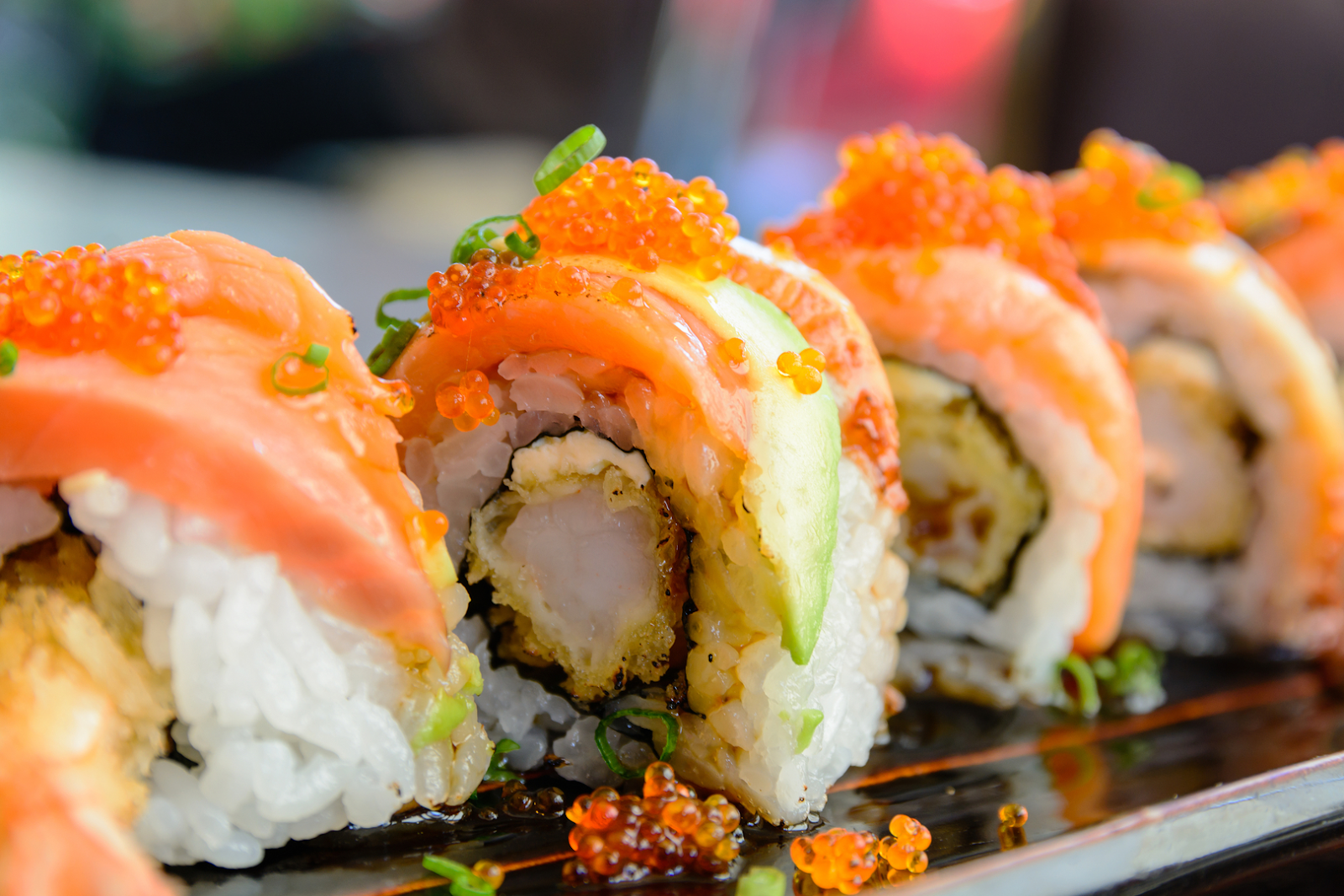 Sushi roll with salmon, avocado, and roe