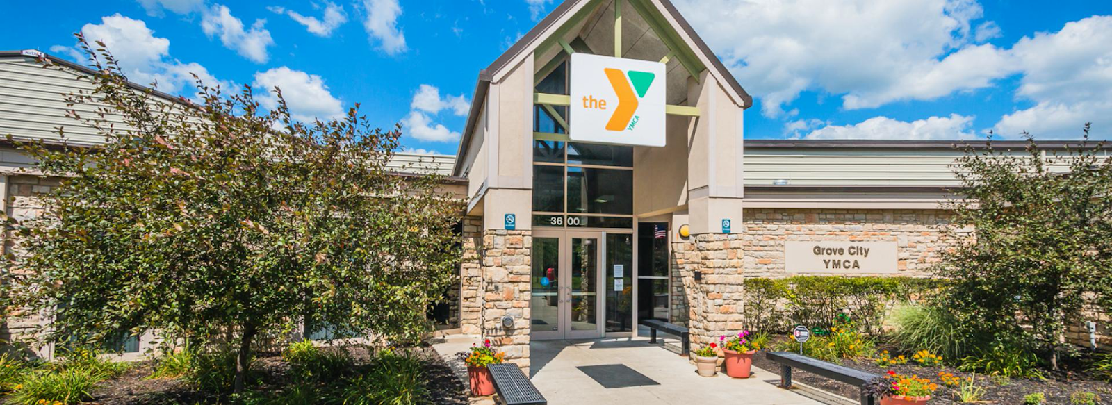 Outside of the Grove City YMCA. Build is long and made of stone.