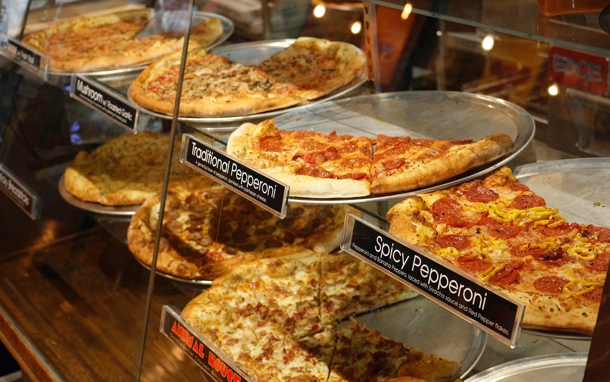 different pizzas in case at Mikey's Late Night Slice