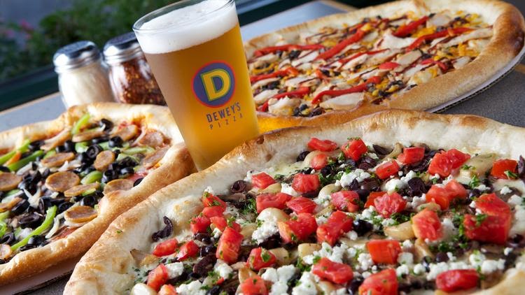 a cold beer and three pizzas