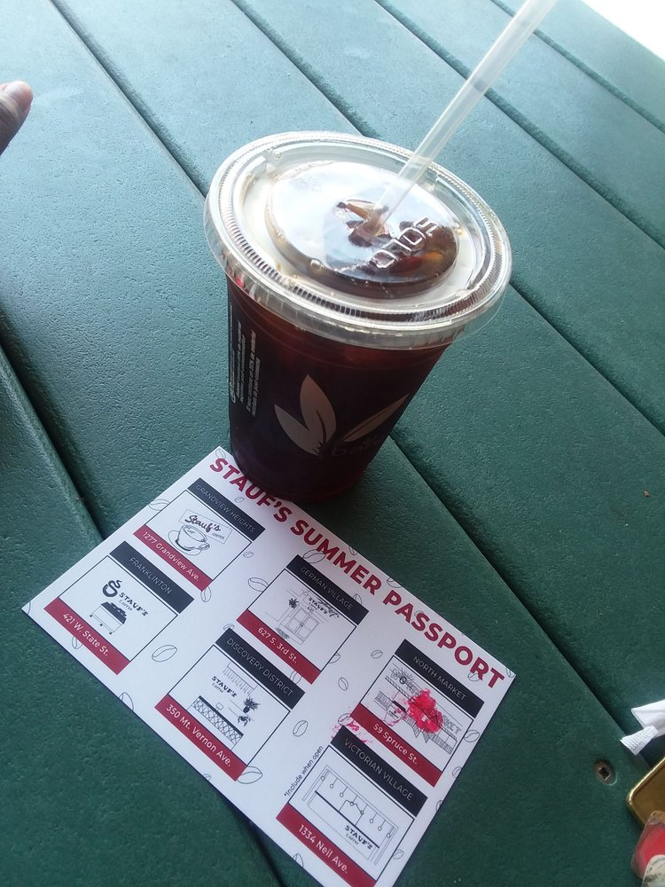 iced coffee with Stauf's Summer Passport next to it.