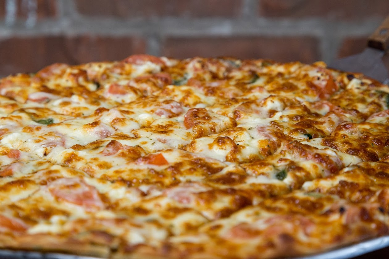 Pizza with toppings covered in cheese