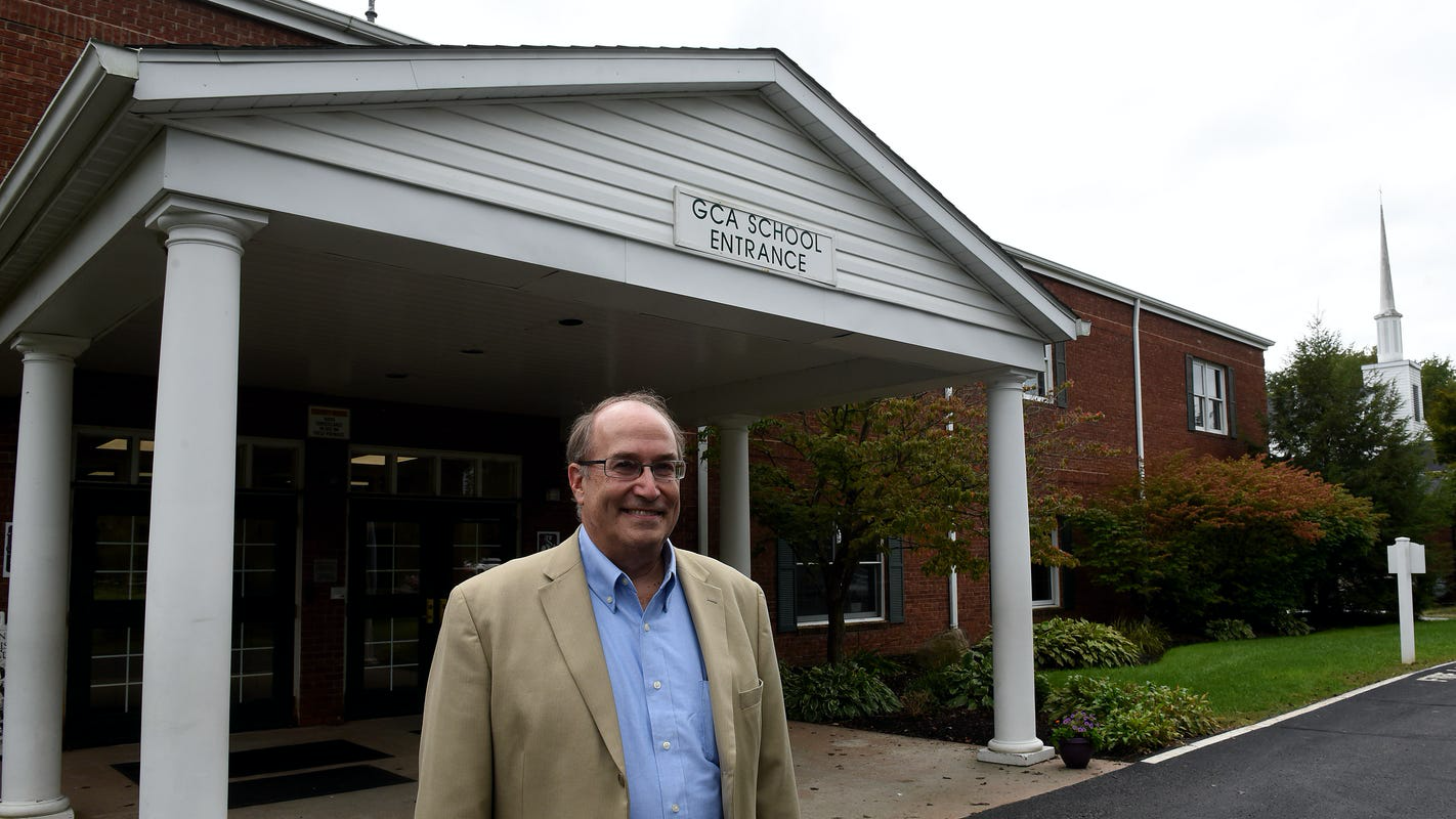 man standing outside of Granville Christian Academy