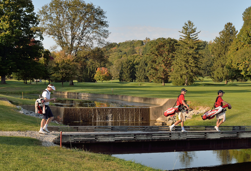 men with golf bags walking at the Denison Golf Club