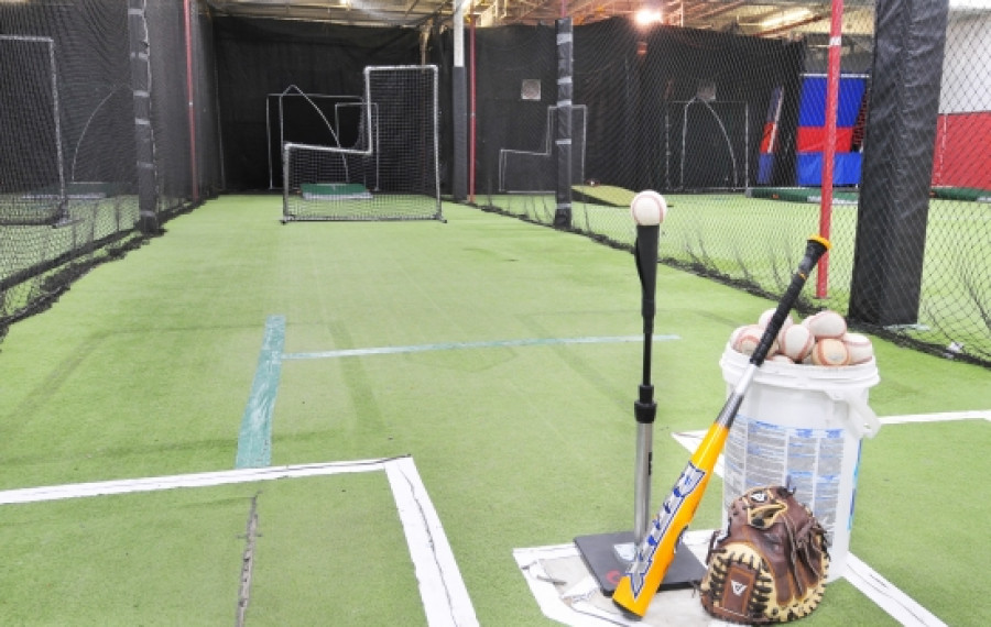 indoor batting cage with green floor