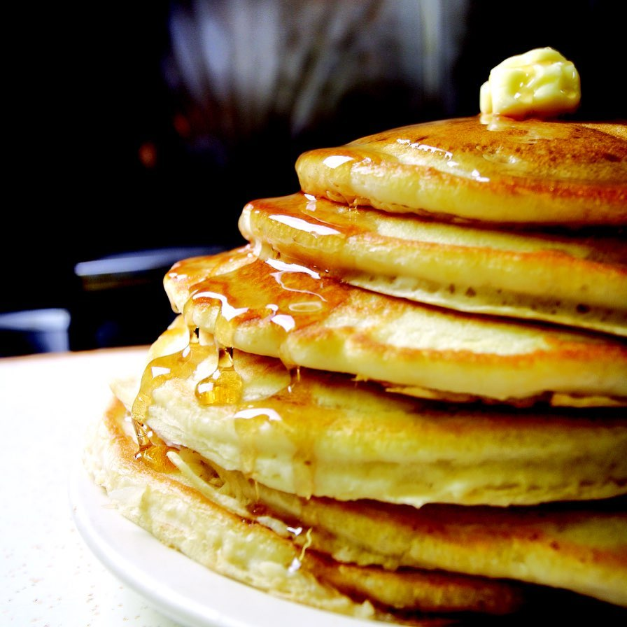 Pancakes with Butter and Maple Syrup on White Plate