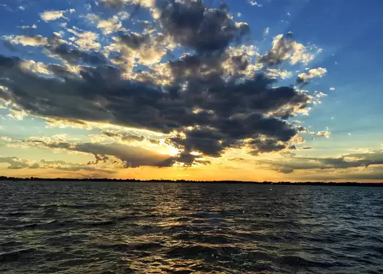 a lake under a beautiful sunny sky