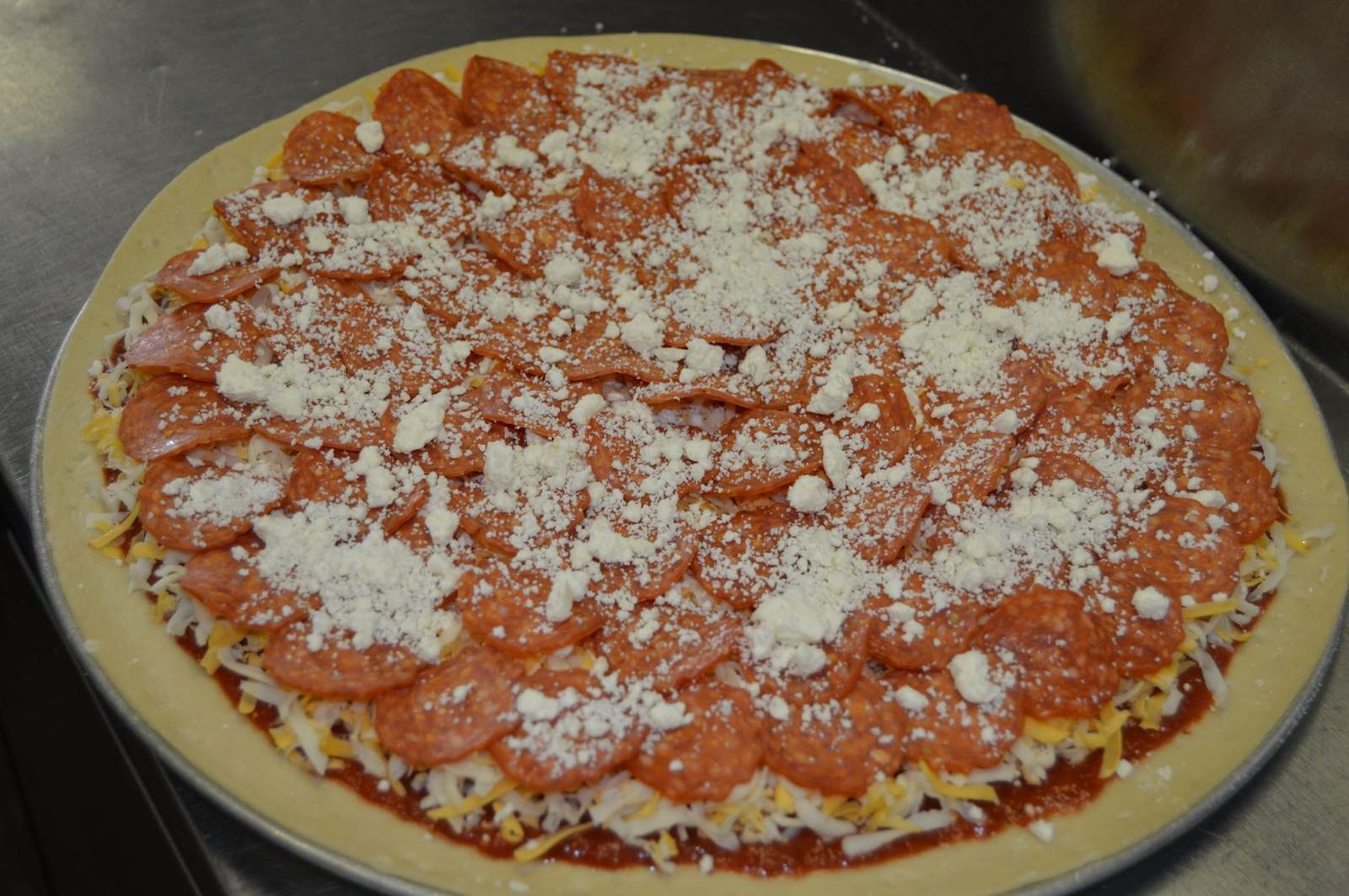 uncooked pepperoni pizza from Casa Di Pizza